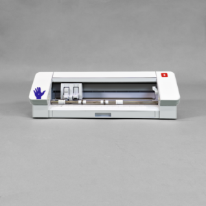 A silhouette cameo plotter sits in the middle of a grey background. The plotter is white, short and wide.